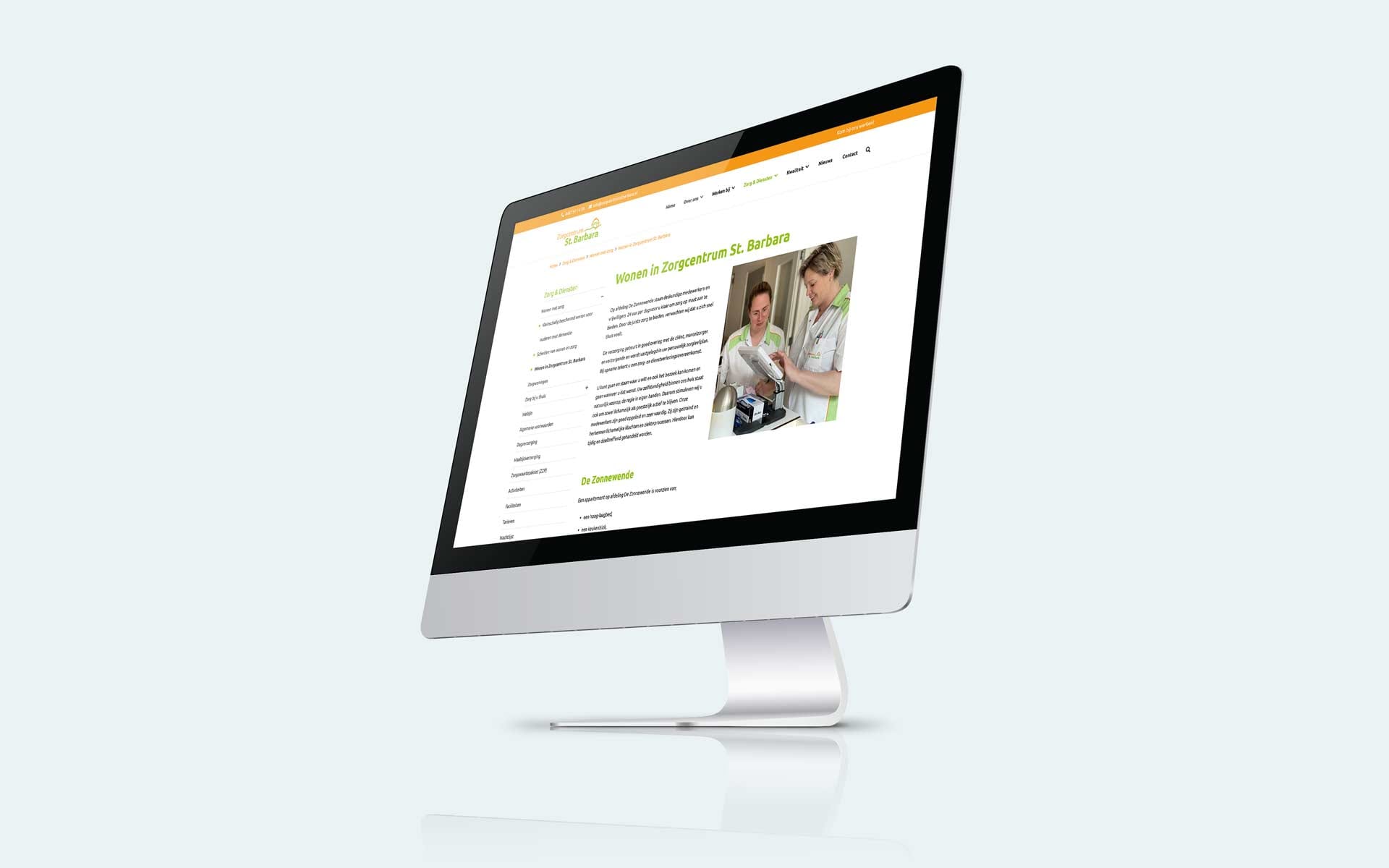 Pagina met zorgmedewerkers op de website van Zorgcentrum St. Barbara op een iMac