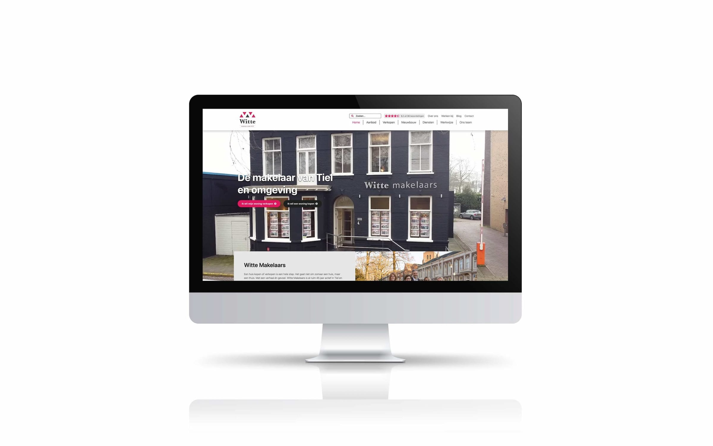 Homepage van Witte Makelaars met het kantoorpand op een iMac